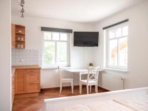 a dining room with a table and two chairs at Reiterhof und Pension Eichenhof in Haiger