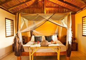 a bedroom with a bed with a canopy at Totoco Eco-Project in Balgue