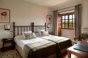 a bedroom with a large bed and a large window at Parador de Tui in Tui
