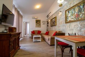 Una sala de estar con un sofá y una pared de piedra. en Villa Lantina, en Betina