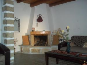a living room with a couch and a fireplace at Vafes Traditional Stone Houses in Vafés