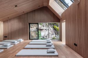 a room with a row of yoga mats on the floor at Miramonti Boutique Hotel in Avelengo