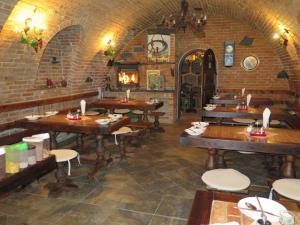 a restaurant with wooden tables and a fireplace at Chata Salma Jeseníky in Dolní Moravice