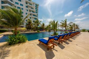a row of lounge chairs next to a swimming pool at Morros Epic 216 in Cartagena de Indias