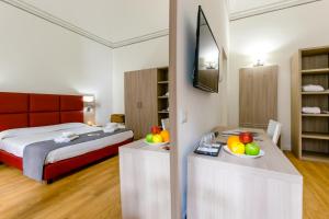 Televiisor ja/või meelelahutuskeskus majutusasutuses Belmonte102 Esclusive Suites