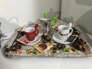 a tray with two coffee cups and a tray of food at La casetta di Ester in Ercolano +15 photos