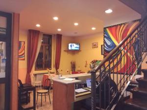 a living room with a desk and a staircase at Hotel San Giovanni in Milan