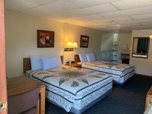 a hotel room with two beds in a room at Chief Motel in Custer