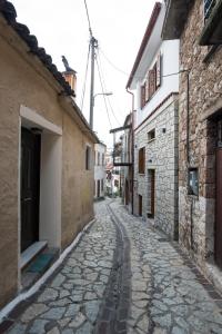 an alley in an old town with stone buildings at Blue Mountain Guesthouse by Seablue in Arachova