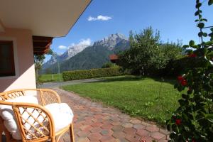 a patio with two chairs and a view of a mountain at Ferienwohnungen Christine in Waidring +4 photos