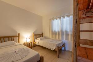 Cama ou camas em um quarto em Village Muta