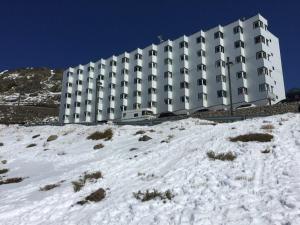 un gran edificio blanco en lo alto de una colina nevada en PRESIDENTE CON ENCANTO en Sierra Nevada