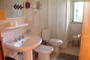a bathroom with a sink and a toilet at Villa Grazia in Noto Marina
