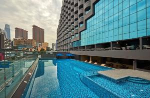 a large swimming pool in front of a building at Swiss-Garden Hotel Bukit Bintang Kuala Lumpur in Kuala Lumpur