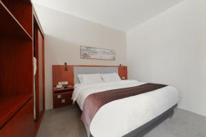 Postel nebo postele na pokoji v ubytování Shanghai Menglong Hotel Management