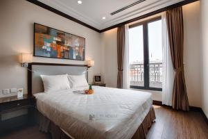a bedroom with a large bed and a large window at CityHouse - Atelier Thảo Điền in Ho Chi Minh City
