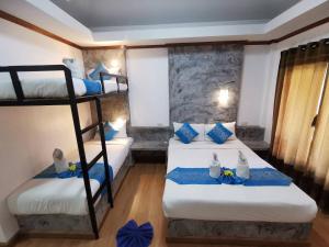 a room with two bunk beds with blue pillows at Lanta Sunny House in Ko Lanta +46 photos