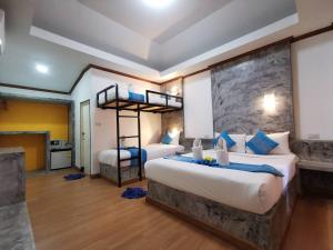 a bedroom with two beds and a bunk bed at Lanta Sunny House in Ko Lanta +56 photos