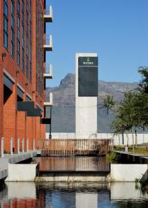 a building with a sign in the middle of a river at Six One Five at Matrix in Cape Town