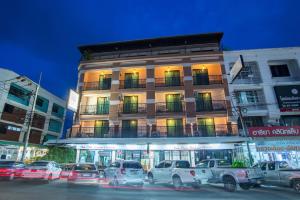 a building with cars parked in front of it at Lada Krabi Residence Hotel - SHA Plus in Krabi town