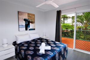 a bedroom with a bed and a balcony at Grande Florida Beachside Resort in Gold Coast