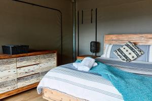 a bedroom with a bed and a dresser at Lorne Foreshore Caravan Park in Lorne