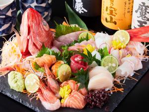 a plate of sushi with shrimp and other vegetables at APA Hotel & Resort Yokohama Bay Tower in Yokohama