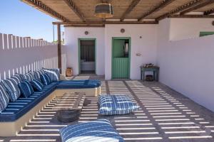 a row of blue pillows sitting on a patio at Ailouros Scenic Guest Houses in Schinoussa