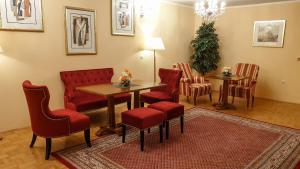 a waiting room with a table and chairs at Hotel Imperium in Moravske-Toplice