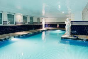 a swimming pool with a statue in the middle of it at Crown Spa Hotel Scarborough by Compass Hospitality in Scarborough
