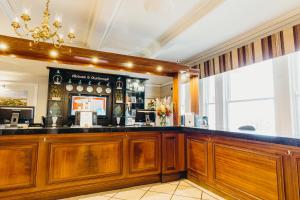 a bar in a restaurant with a counter at Crown Spa Hotel Scarborough by Compass Hospitality in Scarborough