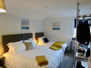 a bedroom with two beds with towels on them at Reading Serviced Rooms in Reading
