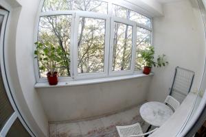 an empty room with a window and a chair at COLORED HOUSE Apartments in Sofia +94 photos