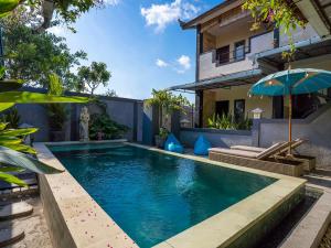 a swimming pool in the backyard of a house at Terrace Garden Homestay and Spa in Jimbaran