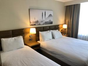 a hotel room with two beds and two lamps at Hotel Fehmi Bey - Special Category in Istanbul