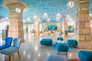 una hall con soffitto blu, sedie e tavolo di Amadria Park Kids Hotel Andrija a Šibenik