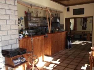 a bar in a house with a person standing behind it at Gasthaus Vogelgarten in Eislingen