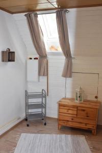 a room with a window and a wooden dresser and a table at Ferienwohnung Lahann in Bokelrehm