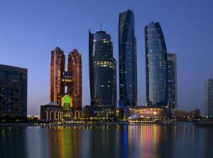 a view of a city skyline at night at Bab Al Qasr Hotel in Abu Dhabi