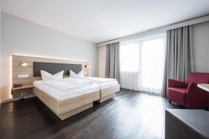 Postel nebo postele na pokoji v ubytování Landhotel Traube