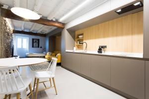 a kitchen with a counter and a table and chairs at Kabia by Smiling Rentals in Hondarribia