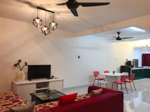 a living room with a red couch and a table at Botanic Gardens 26- 5-bedroom Near AEON Bukit Tinggi in Klang
