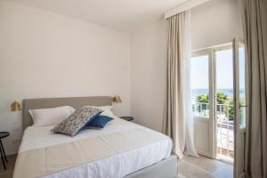 a bedroom with a bed with a view of the ocean at Palazzo Mulini in Monopoli