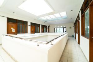 a pool table in a hall with a skylight at KoolKost near Padjadjaran University - Minimum Stay 6 Nights in Bandung