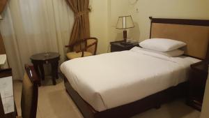 Rúm í herbergi á Al Muntazah Plaza Hotel