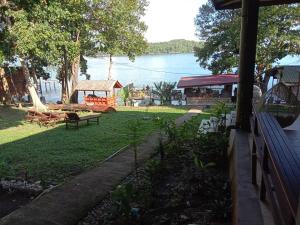 a backyard with a picnic table and a playground at Pele's Place in Sabong