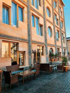 a building with tables and chairs in front of it at Bayil Breeze Hotel & Restaurant in Baku