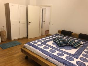 a bedroom with a bed with two pillows on it at Ferienwohnung Eiskögerl im Barbarahof in Bischofshofen