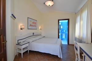Postel nebo postele na pokoji v ubytování Li Suari Club Village