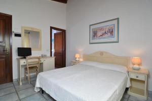 Postel nebo postele na pokoji v ubytování Li Suari Club Village